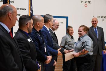 Peru State College Officer Intern Cherise Womelsdorf shakes hands with Peru State College President Dr. Michael Evans